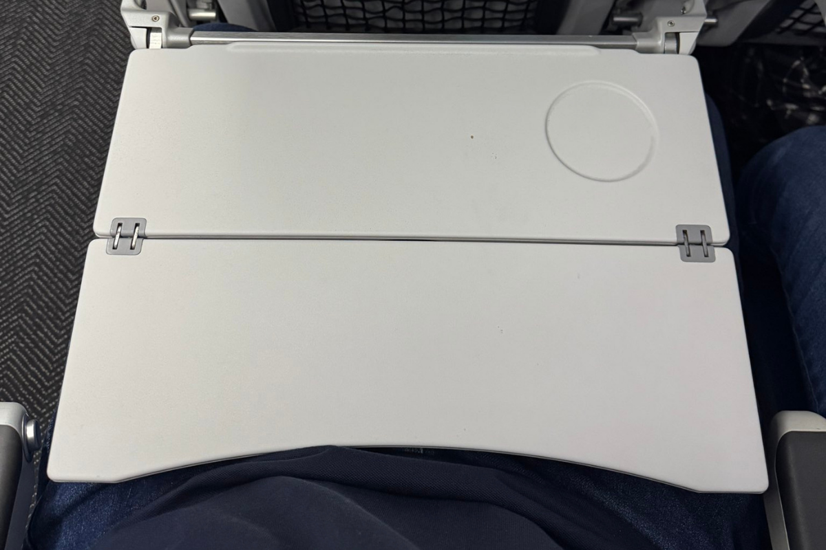 a closr up of a tray table on a united airlines plane