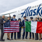 flight crew holding flags in front of an alaska airlines boeing 787