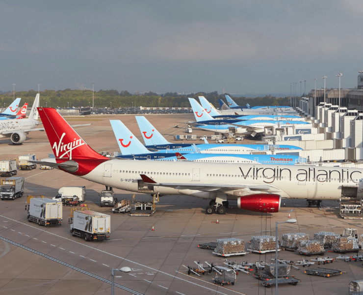 planed lined up at gates at manchester airport