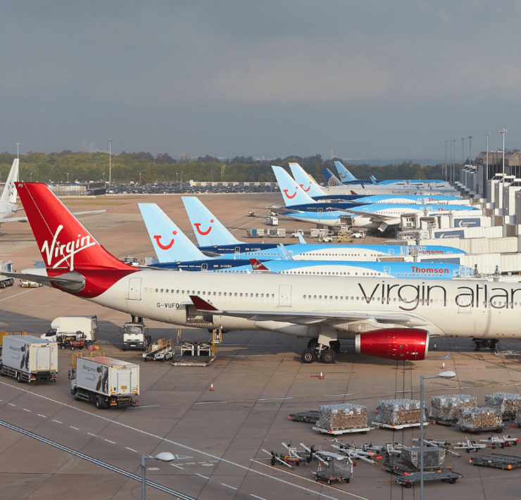 planed lined up at gates at manchester airport