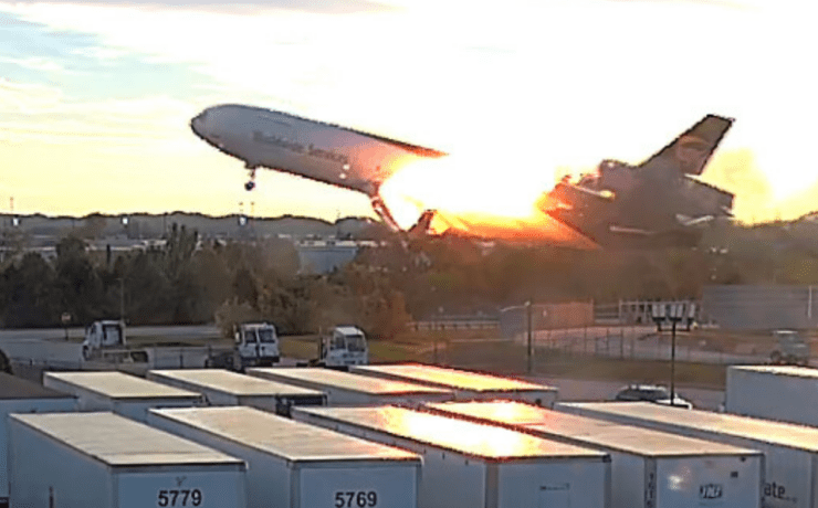 a surveillance video still showing a UPS MD-11 on fire