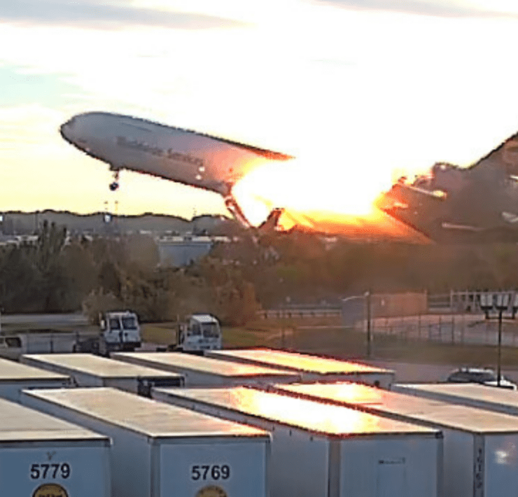 a surveillance video still showing a UPS MD-11 on fire