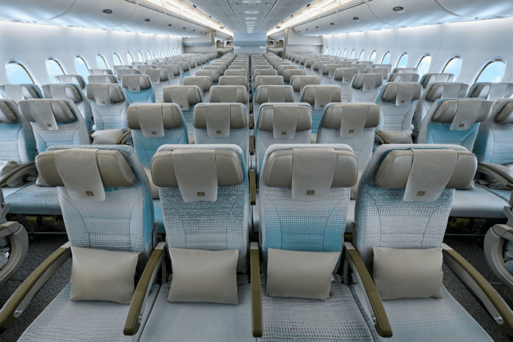 rows of seats in the economy cabin of an emirates airbus a380