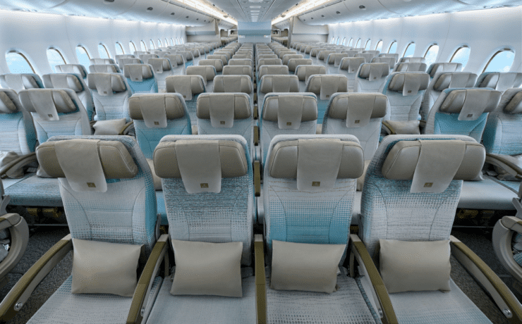 rows of seats in the economy cabin of an emirates airbus a380