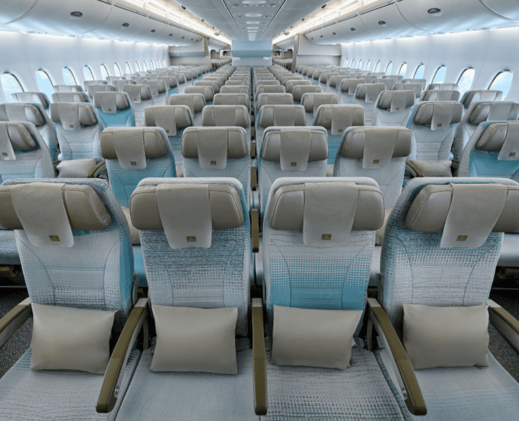rows of seats in the economy cabin of an emirates airbus a380