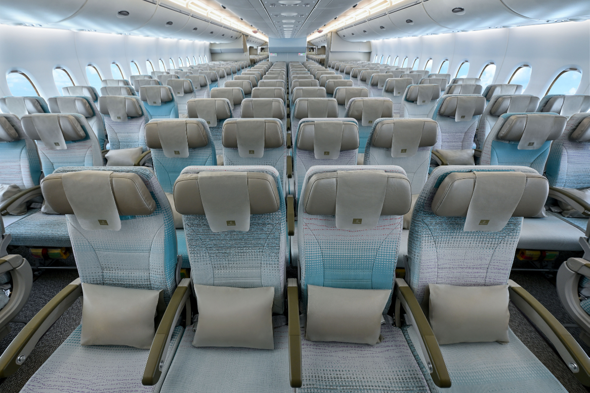 rows of seats in the economy cabin of an emirates airbus a380