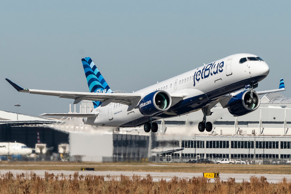 a jetblue a220 taking off