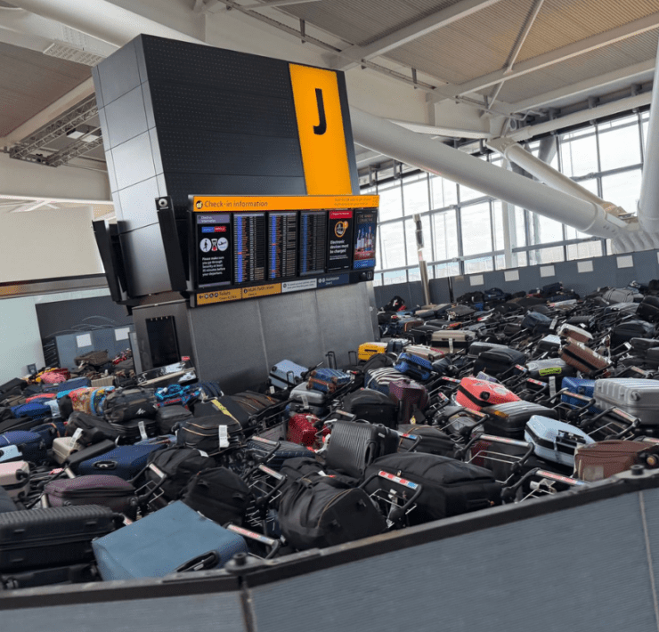 mountains luggage pile up in terminal 5 at heathrow airport