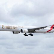 an emirates boeing 777-300 flying in the sky