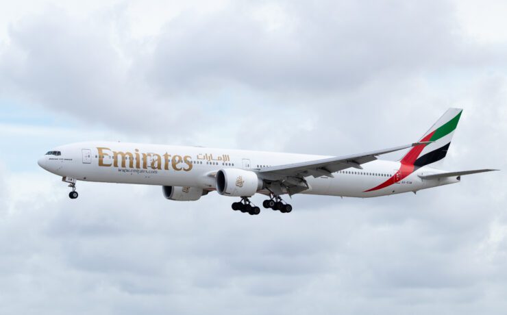 an emirates boeing 777-300 flying in the sky