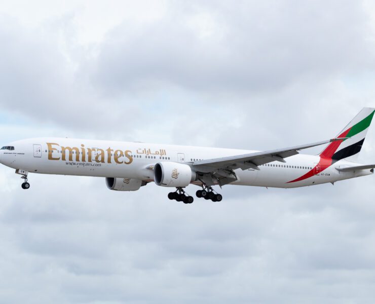 an emirates boeing 777-300 flying in the sky
