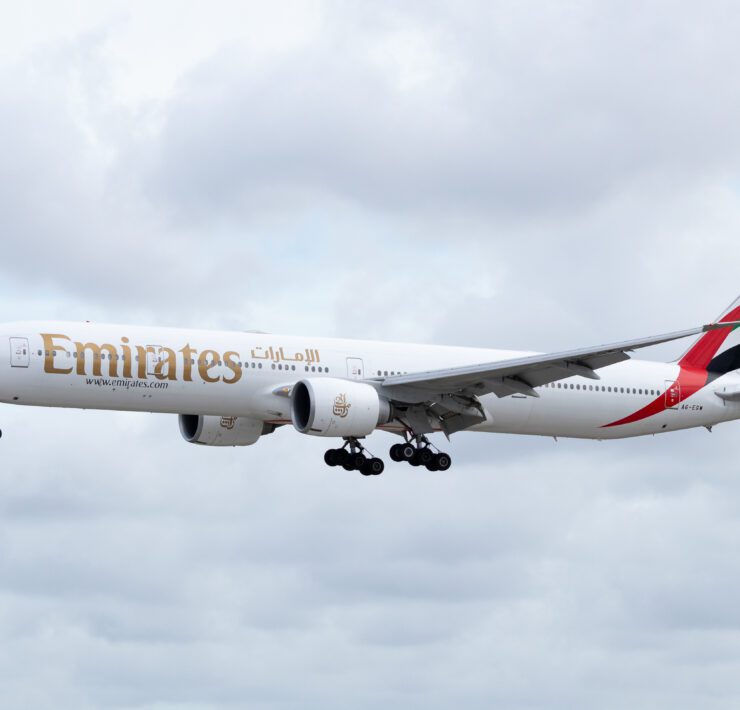an emirates boeing 777-300 flying in the sky