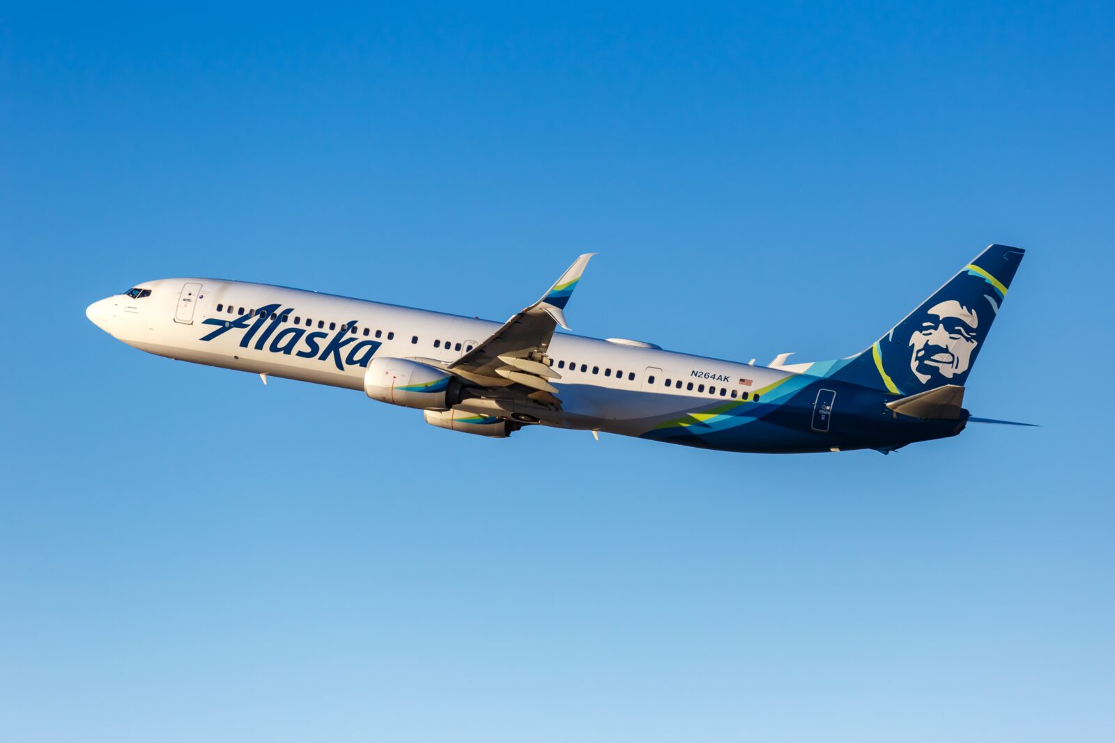 an alaska airlines plane flying in the sky