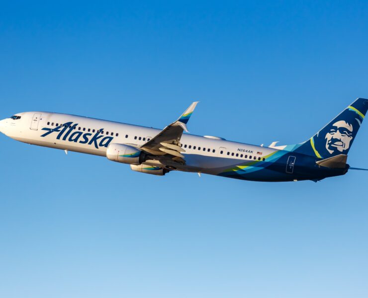 an alaska airlines plane flying in the sky
