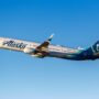 an alaska airlines plane flying in the sky