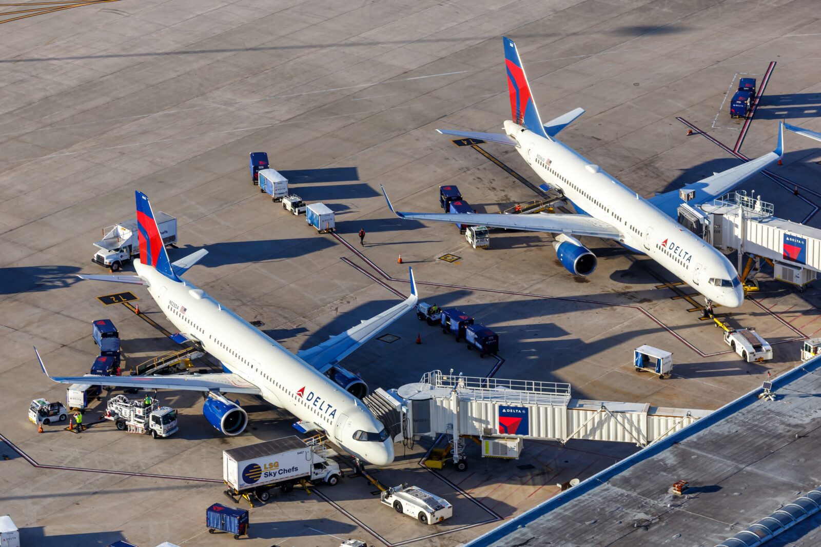 two delta air lines planes parked at the gate at orlando international airport
