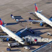 two delta air lines planes parked at the gate at orlando international airport