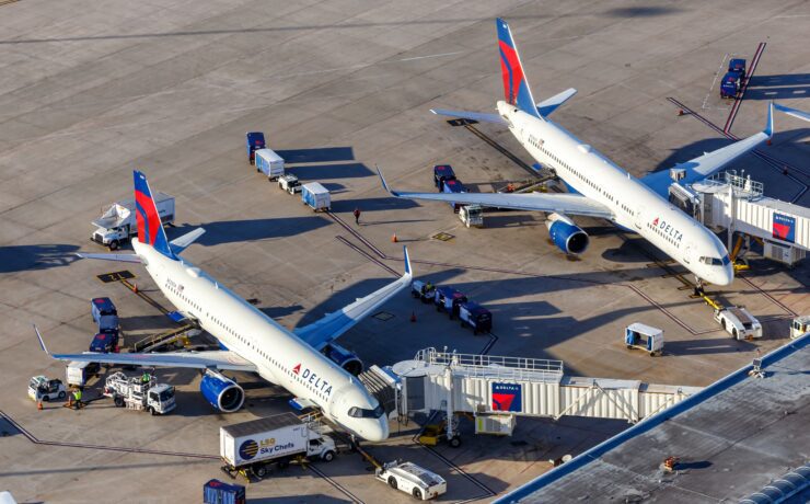 two delta air lines planes parked at the gate at orlando international airport