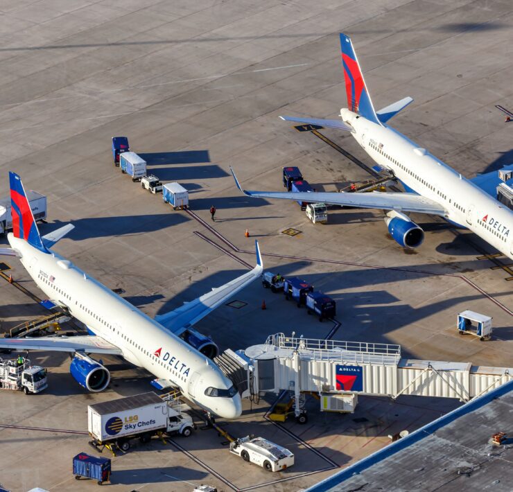 two delta air lines planes parked at the gate at orlando international airport