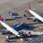 two delta air lines planes parked at the gate at orlando international airport