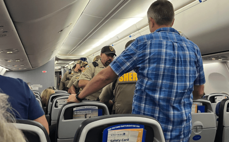 police board a united airlines plane that declared an unruly passenger incident