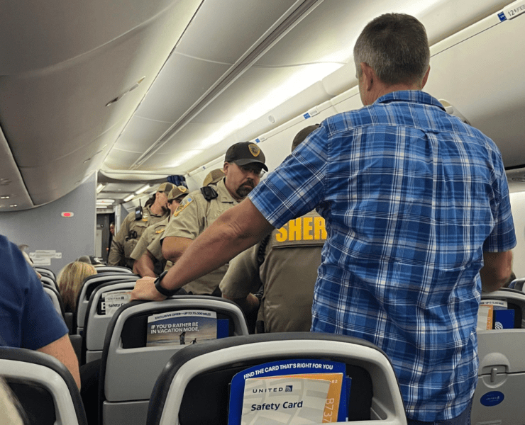 police board a united airlines plane that declared an unruly passenger incident