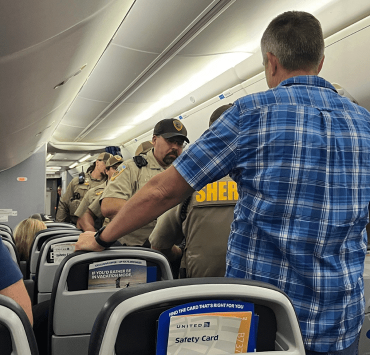 police board a united airlines plane that declared an unruly passenger incident