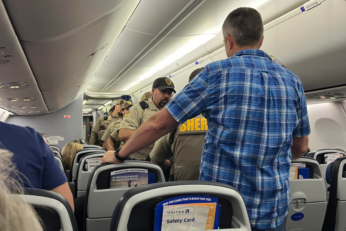 police board a united airlines plane that declared an unruly passenger incident