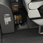 two trays of drinks left on floor of plane