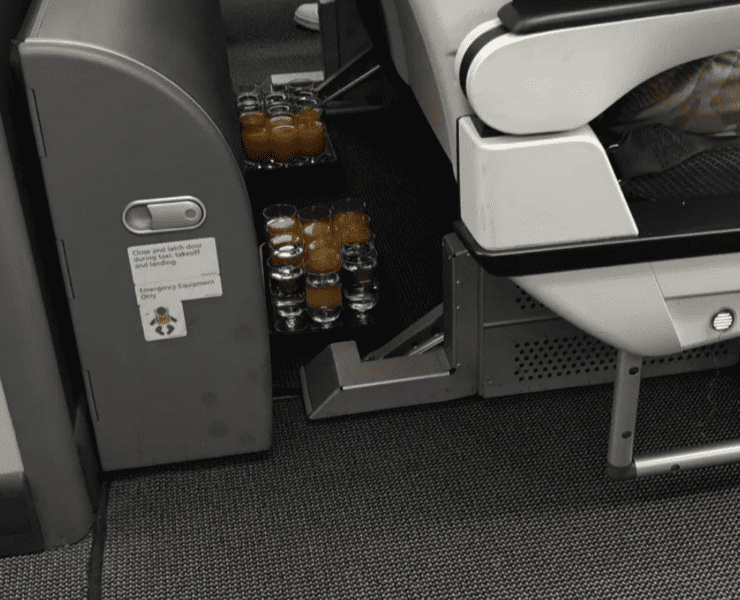 two trays of drinks left on floor of plane