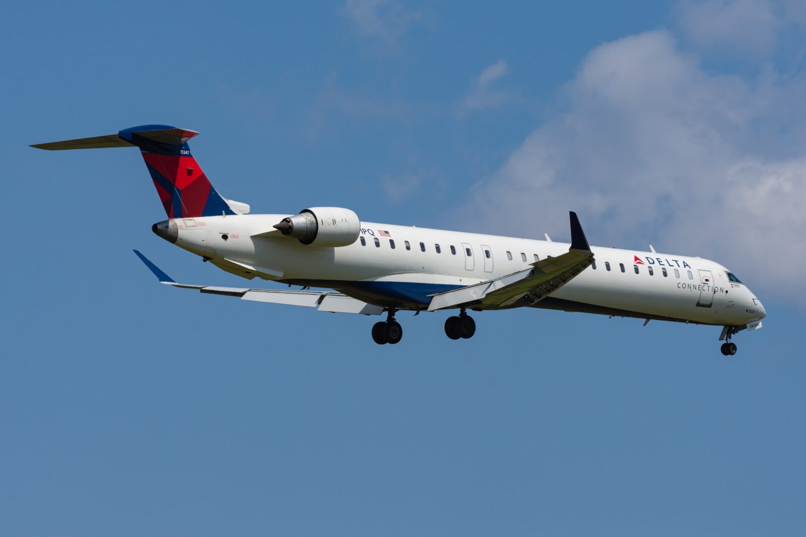 a delta connection airplane flying in the sky