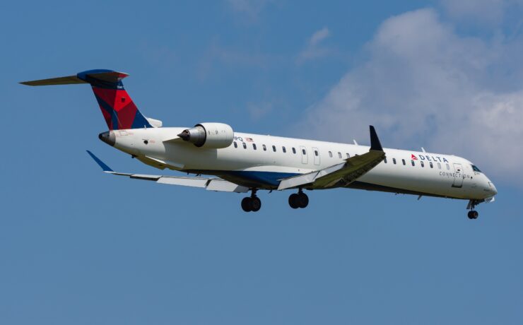 a delta connection airplane flying in the sky