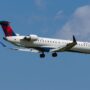 a delta connection airplane flying in the sky