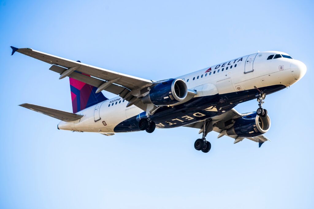 a delta air lines airbus a319 flying in the sky
