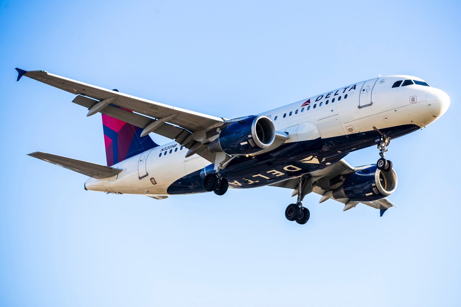 a delta air lines airbus a319 flying in the sky