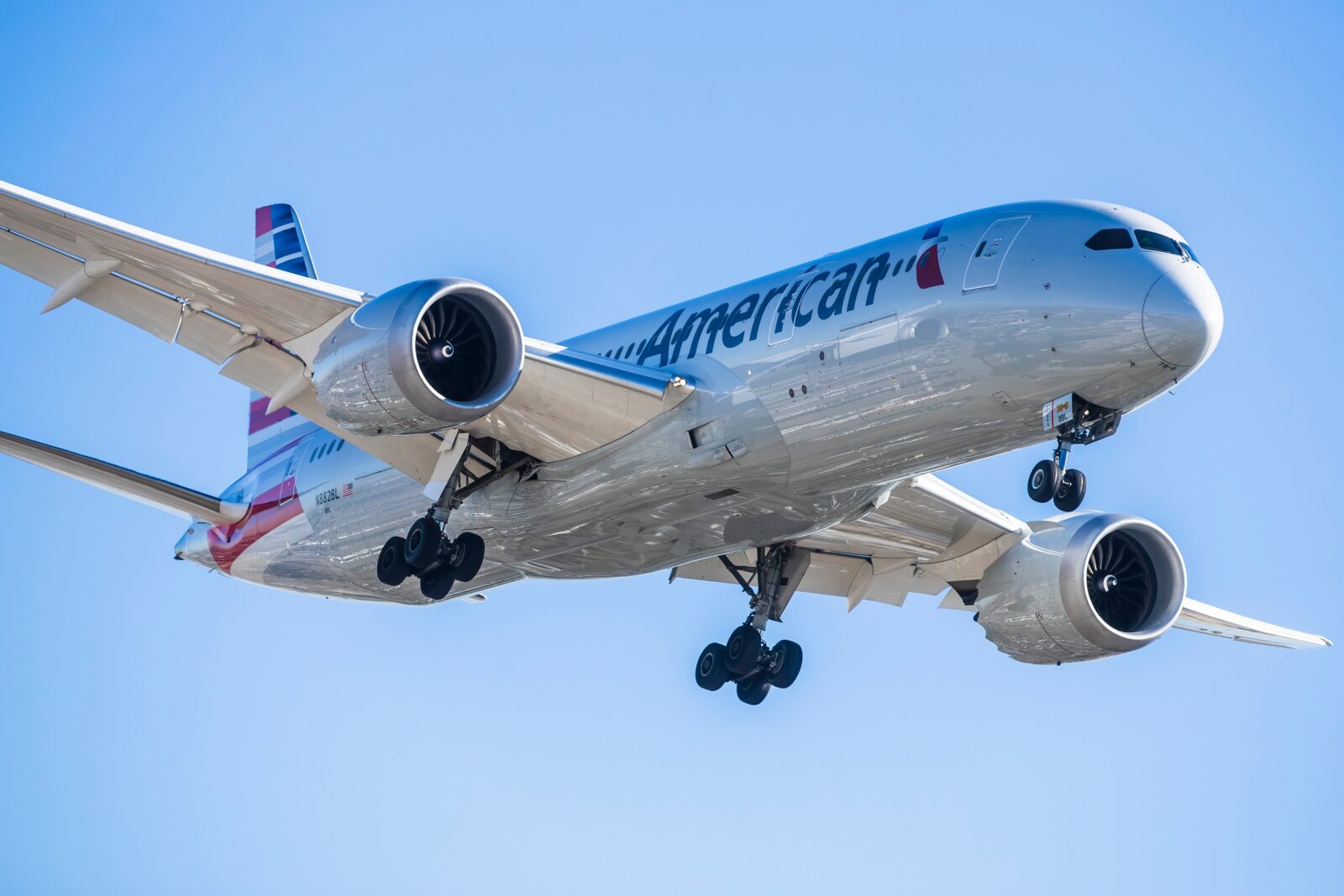 an american airlines boeing 787-9 dreamliner flying in the sky