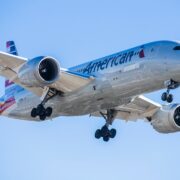 an american airlines boeing 787-9 dreamliner flying in the sky