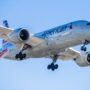 an american airlines boeing 787-9 dreamliner flying in the sky