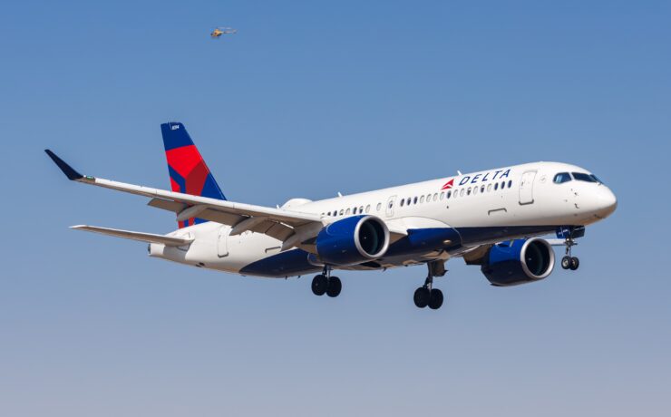 a delta air lines airbus a220 flying in the sky