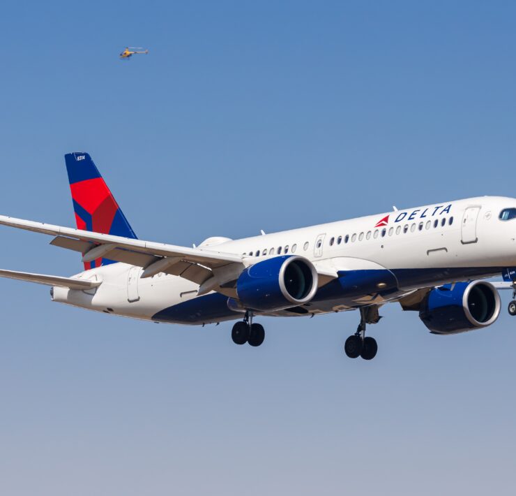 a delta air lines airbus a220 flying in the sky