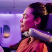 a woman using Emirates' new 'U-Dream' headrest