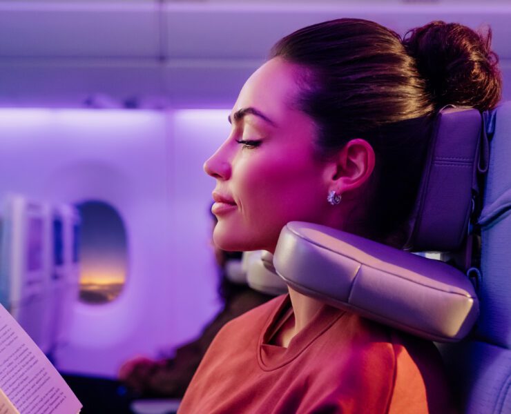 a woman using Emirates' new 'U-Dream' headrest