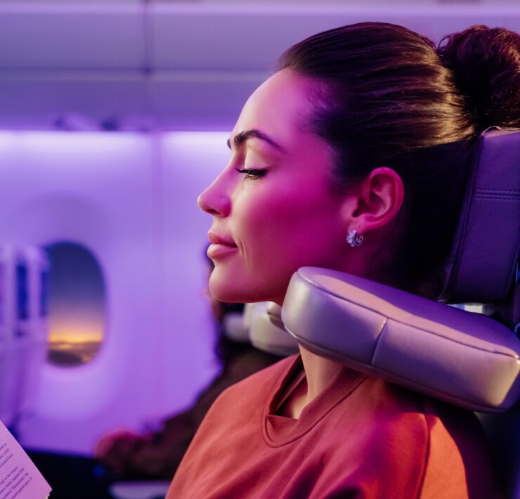 a woman using Emirates' new 'U-Dream' headrest