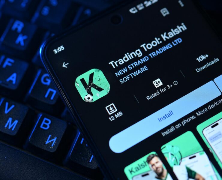 an image of a mobile phone displaying the Kalshi prediction markets map on top of a keyboard